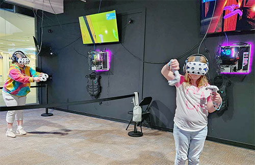 Players enjoying VR games at The White Rabbit VR Arcade in Des Moines, IA