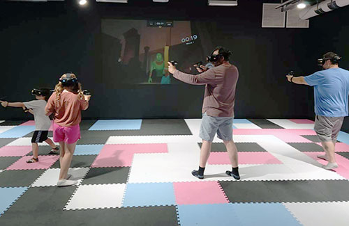 Group enjoying a VR Arena experience at The White Rabbit VR Arcade in Des Moines, Iowa